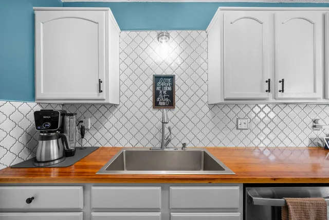 a kitchen with cabinets and white appliances