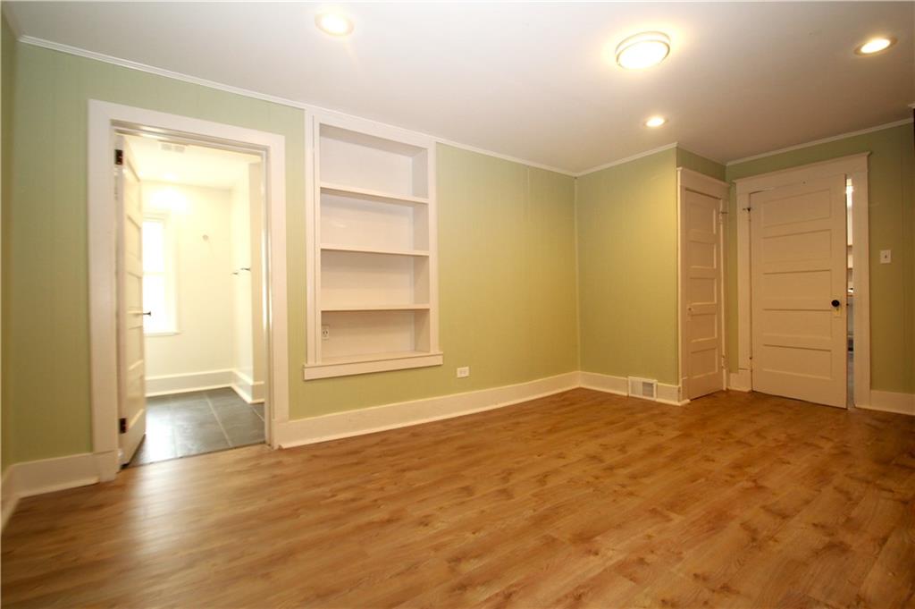 1406 Firth Street, Unit 1 Pittsburgh, PA 15212 - Photo 2 of 19 a view of an empty room with wooden floor and closet area