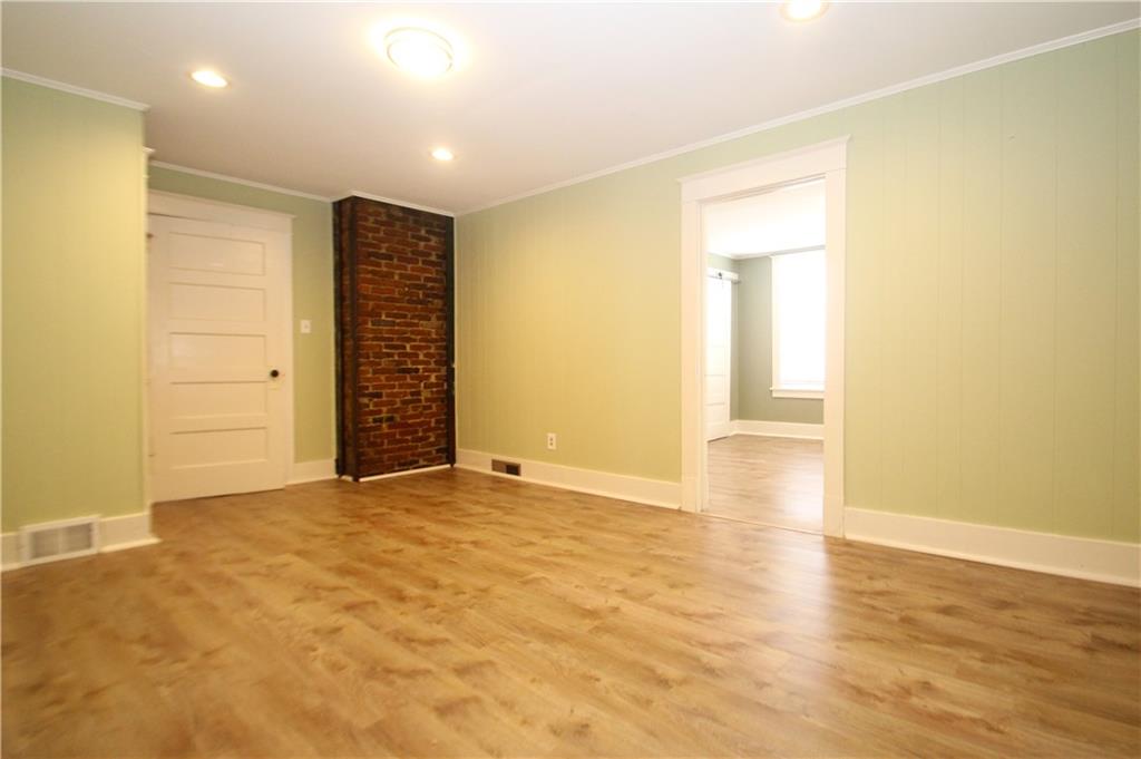 1406 Firth Street, Unit 1 Pittsburgh, PA 15212 - Photo 3 of 19 an empty room with wooden floor and closet