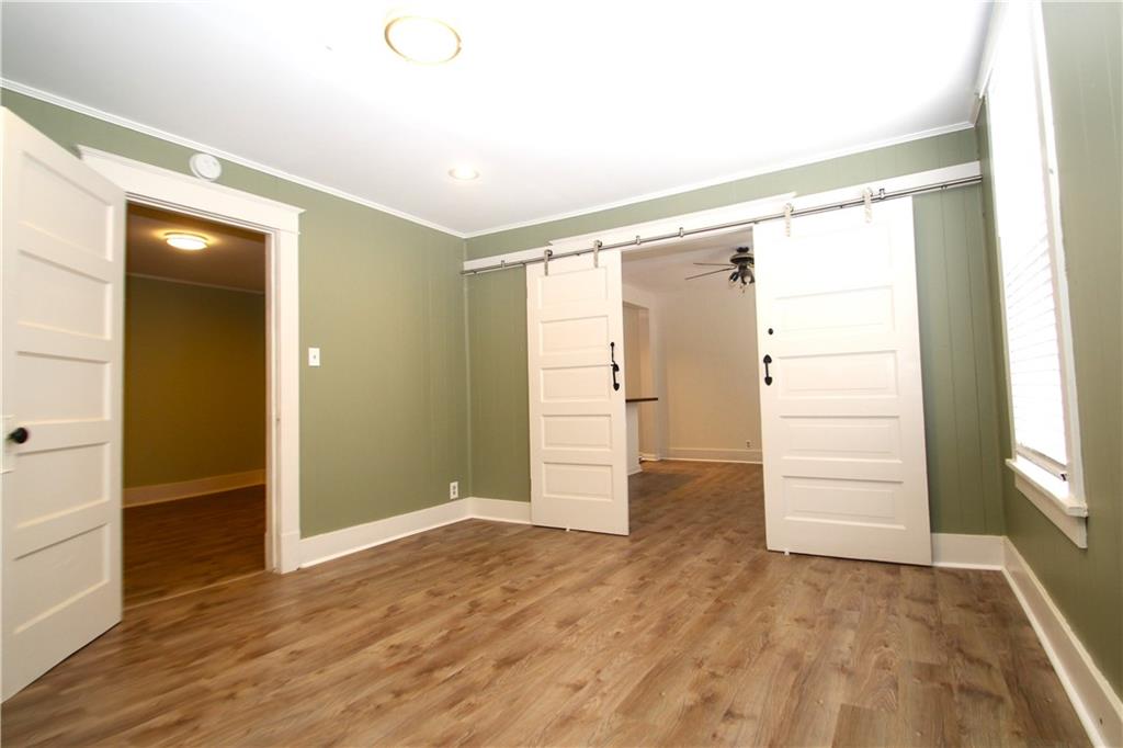 1406 Firth Street, Unit 1 Pittsburgh, PA 15212 - Photo 6 of 19 an empty room with wooden floor cabinet and windows