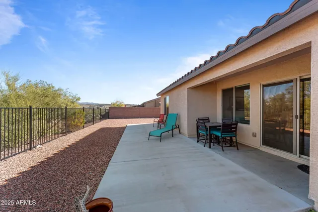a view of a house with backyard and sitting area