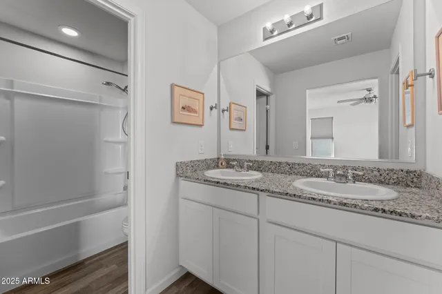 a bathroom with a granite countertop sink mirror and a