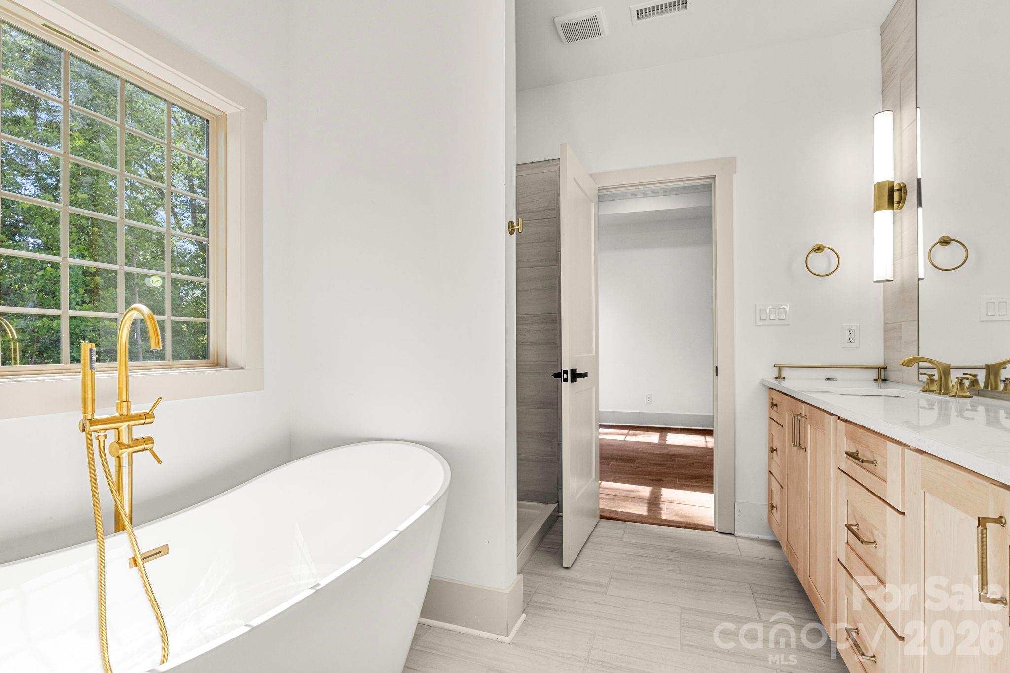 1167 Tirzah Road Rock Hill, SC 29732 - Photo 13 of 25 a spacious bathroom with a granite countertop sink and a mirror