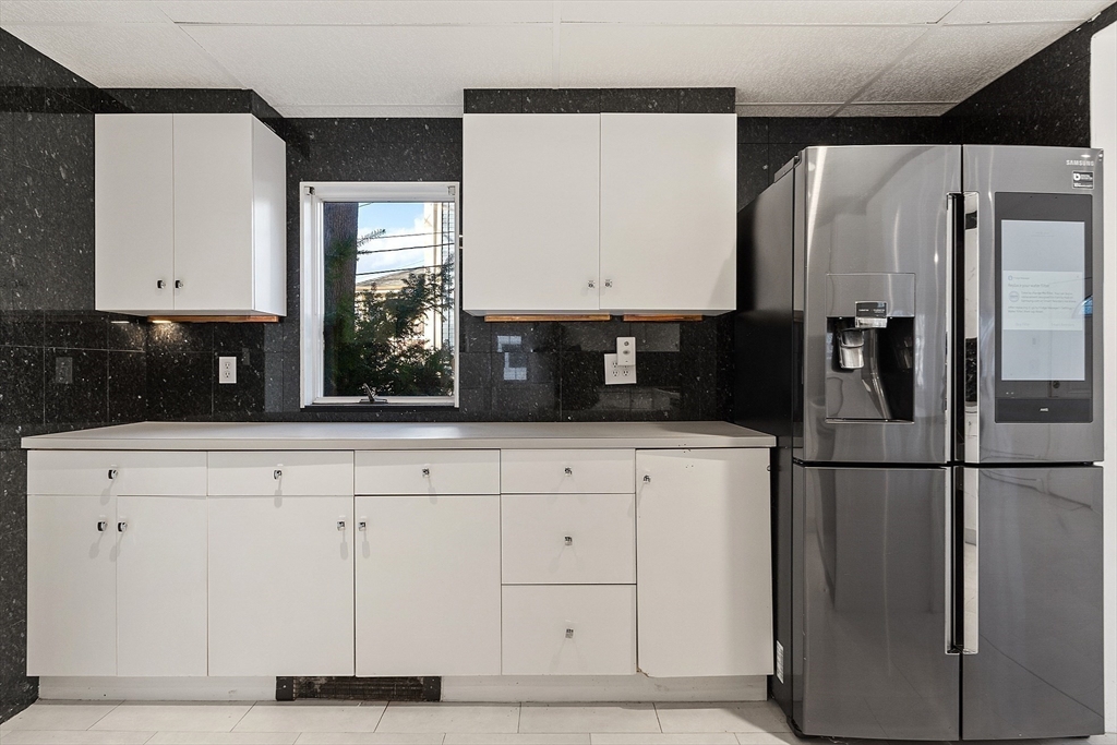 87 Common Street Watertown, MA 02472 - Photo 20 of 41 a kitchen with cabinets and a refrigerator