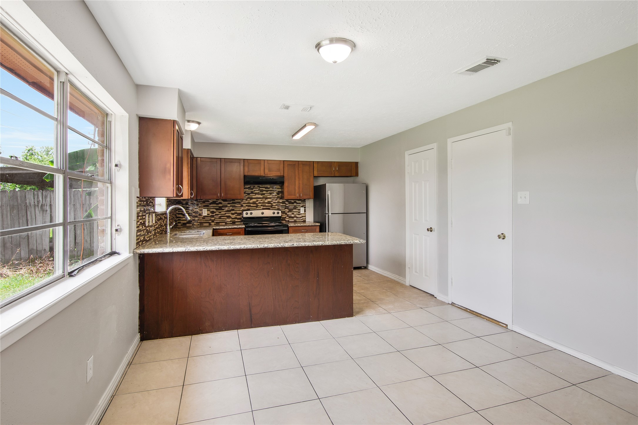 11710 Old Telegraph Road Houston, TX 77067 - Photo 9 of 24 Enjoy updated kitchen with double stainless steel sink, granite countertops, new fridge, new stove, new dishwasher!