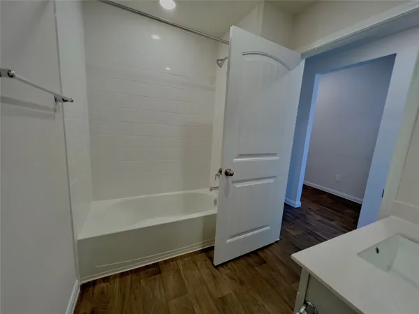 a bathroom with a bathtub and a sink