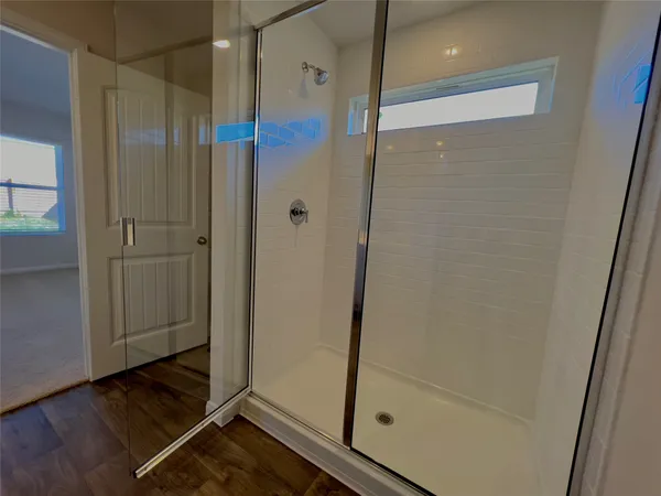a bathroom with a toilet and a shower