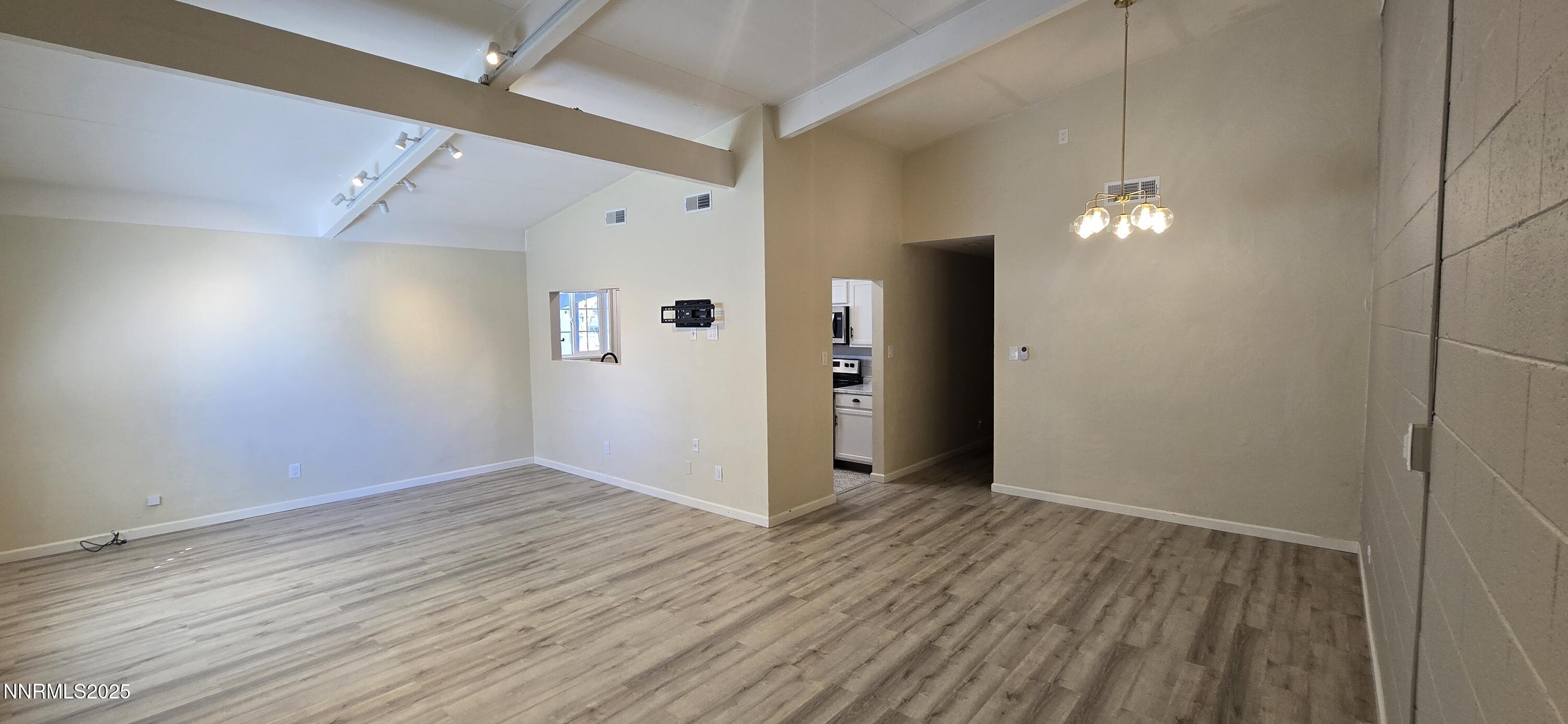 13562 Mt Baldy Street Reno, NV 89506 - Photo 5 of 9 wooden floor in an empty room with a window
