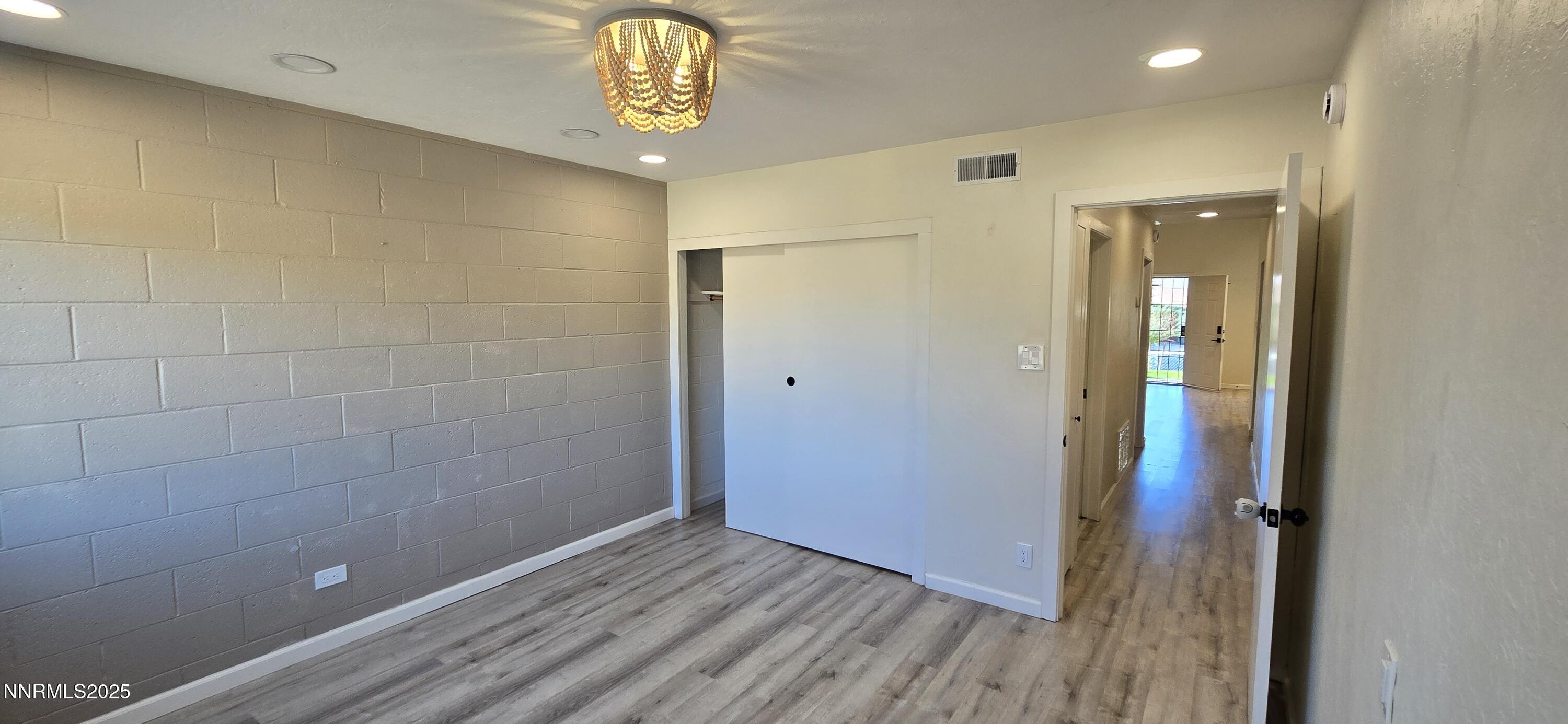 13562 Mt Baldy Street Reno, NV 89506 - Photo 7 of 9 a view of a hallway with wooden floor