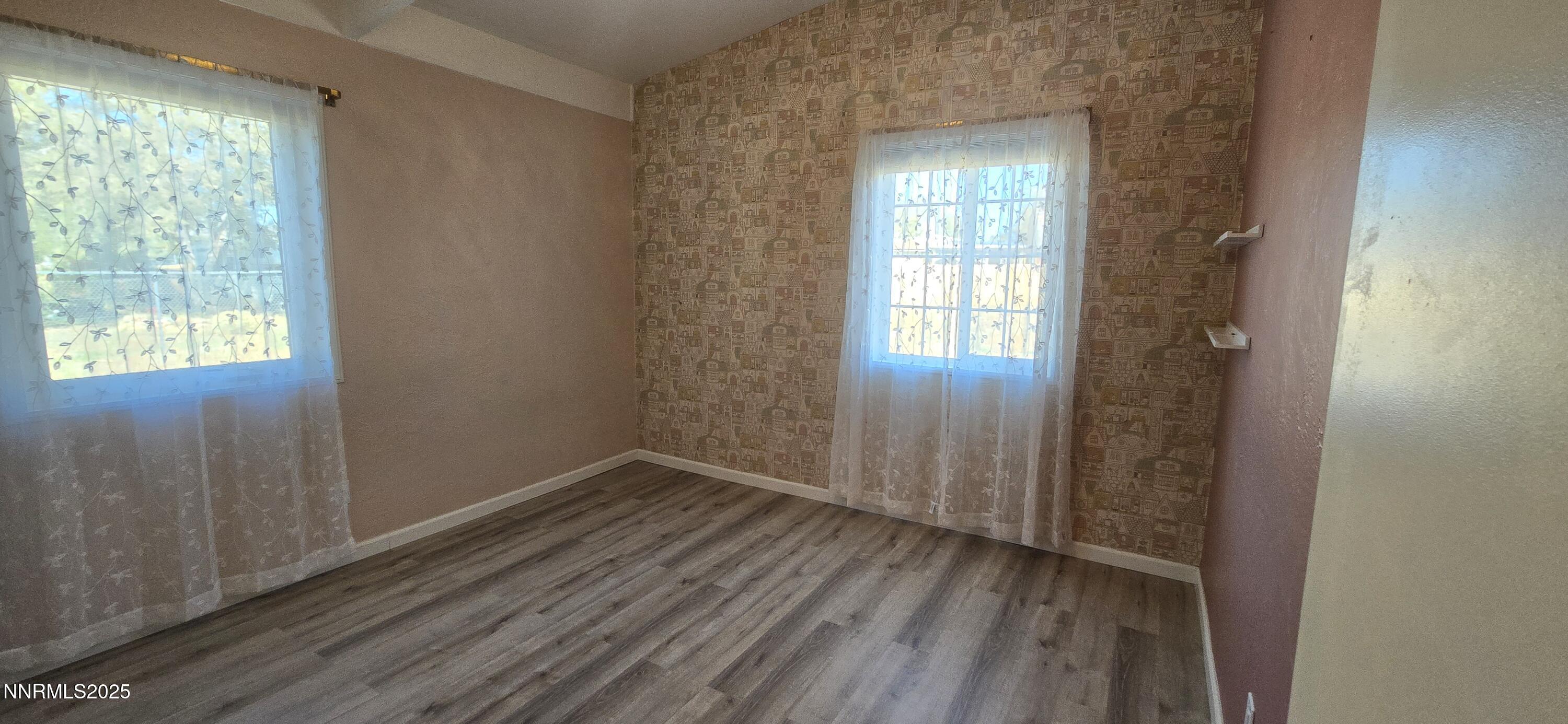 13562 Mt Baldy Street Reno, NV 89506 - Photo 8 of 9 a view of an empty room with wooden floor and a window