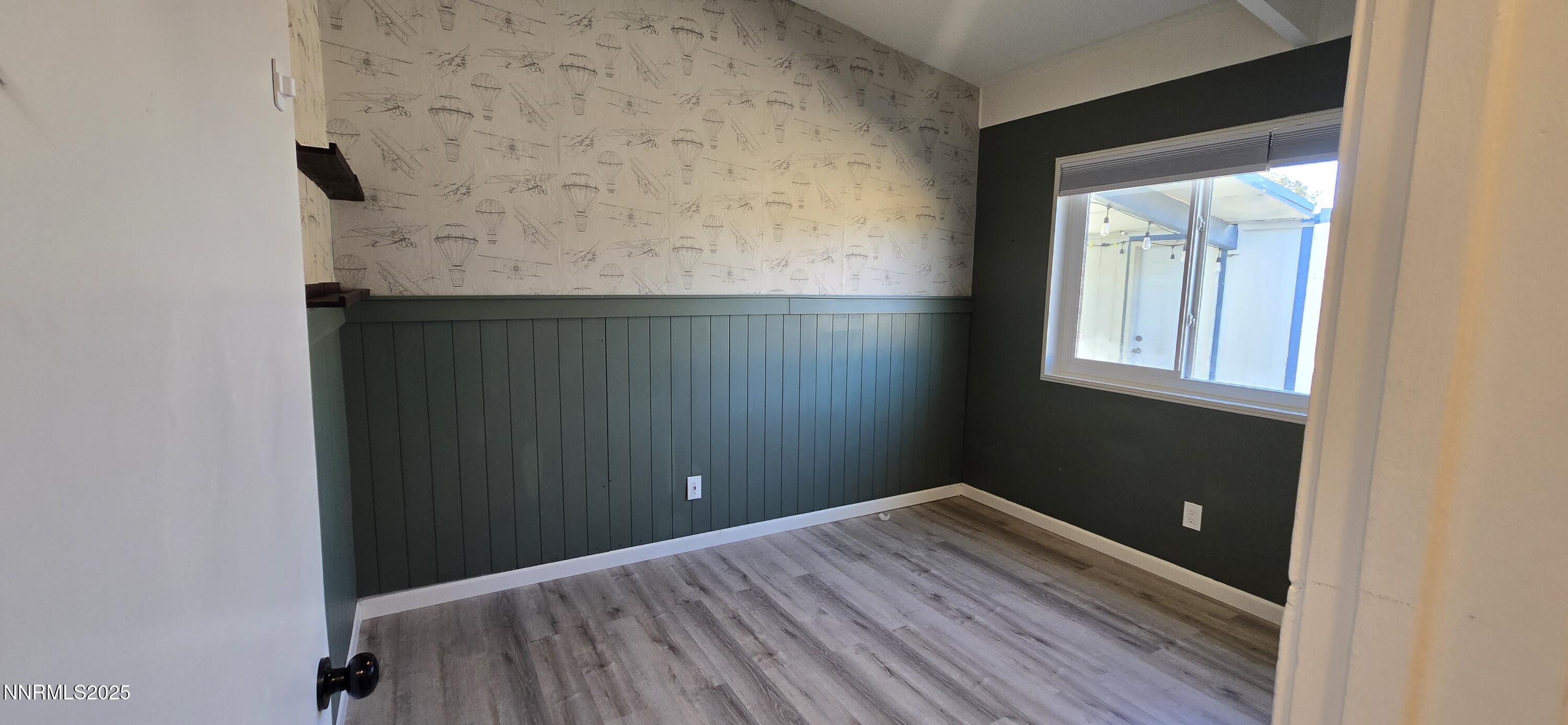 13562 Mt Baldy Street Reno, NV 89506 - Photo 9 of 9 an empty room with wooden floor and cabinet