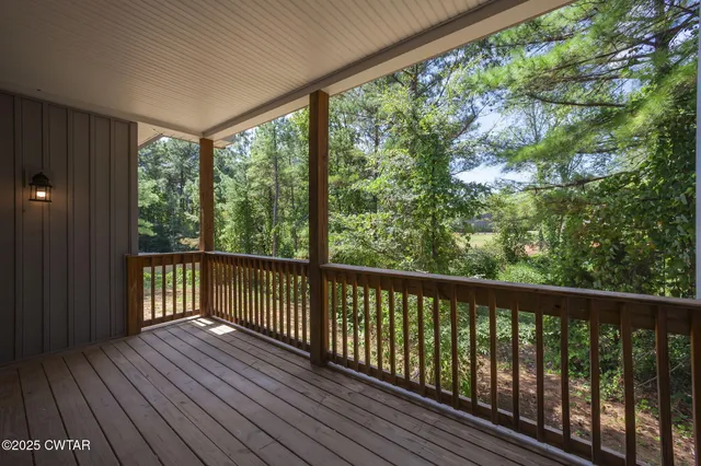 a view of balcony with wooden floor