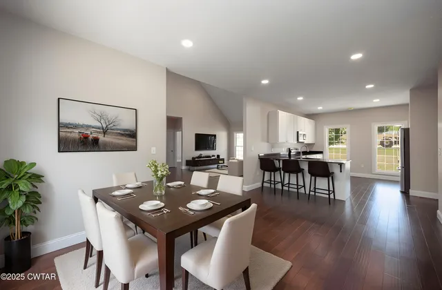 a view of a dining room with furniture and wooden floor