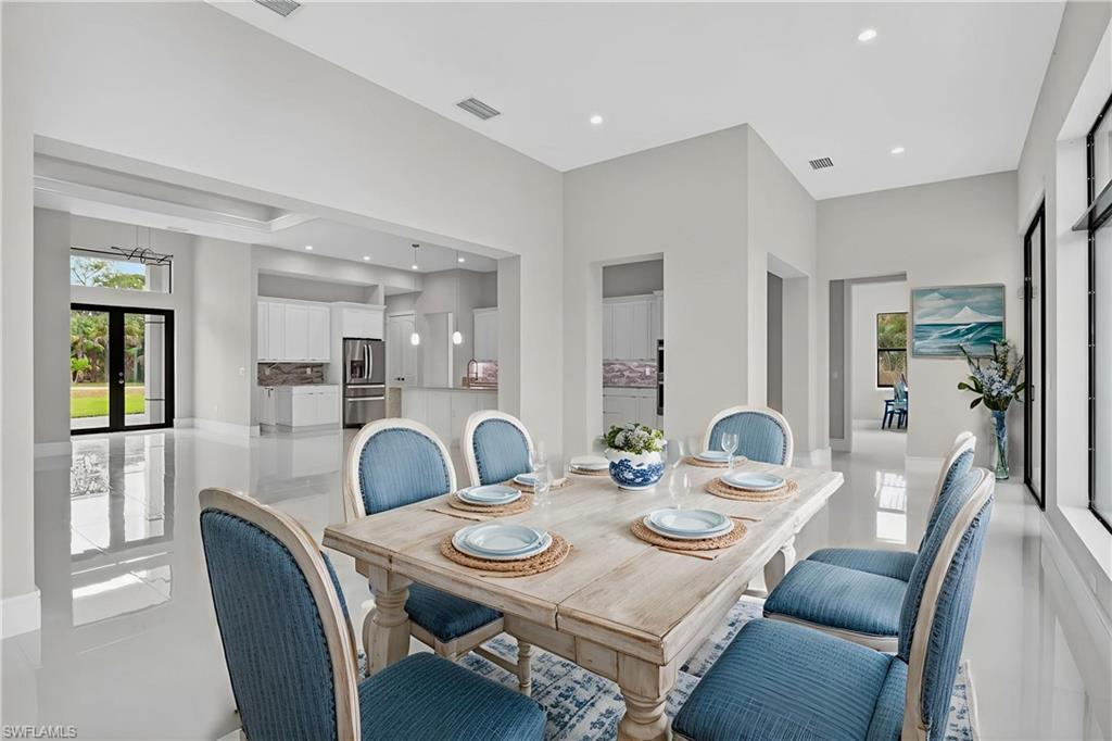 563 15th Street Northwest Naples, FL 34120 - Photo 9 of 33 Dining room with french doors and recessed lighting