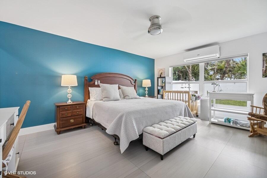 746 Southwest 2nd Street Boca Raton, FL 33486 - Photo 16 of 54 a bedroom with a bed and a couch