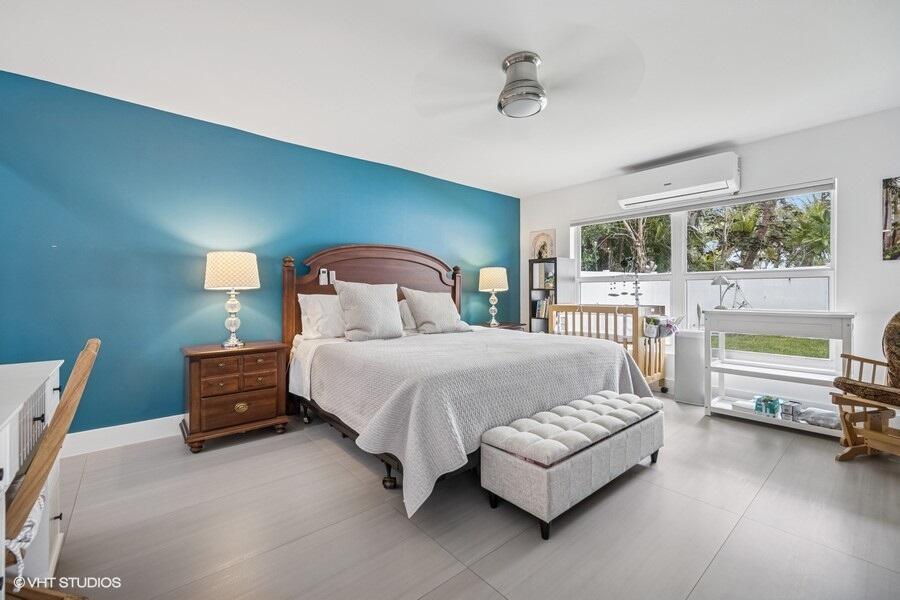 746 Southwest 2nd Street Boca Raton, FL 33486 - Photo 17 of 54 a bedroom with a bed and a night stand