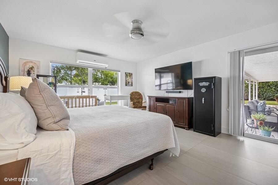746 Southwest 2nd Street Boca Raton, FL 33486 - Photo 19 of 54 a bedroom with a bed and a large window