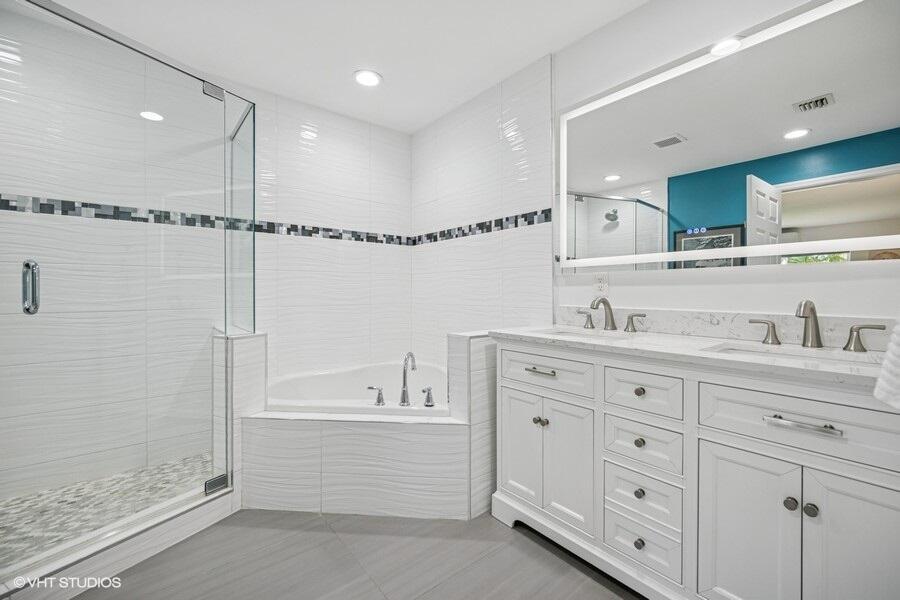 746 Southwest 2nd Street Boca Raton, FL 33486 - Photo 20 of 54 a spacious bathroom with a double vanity sink a mirror and a bathtub