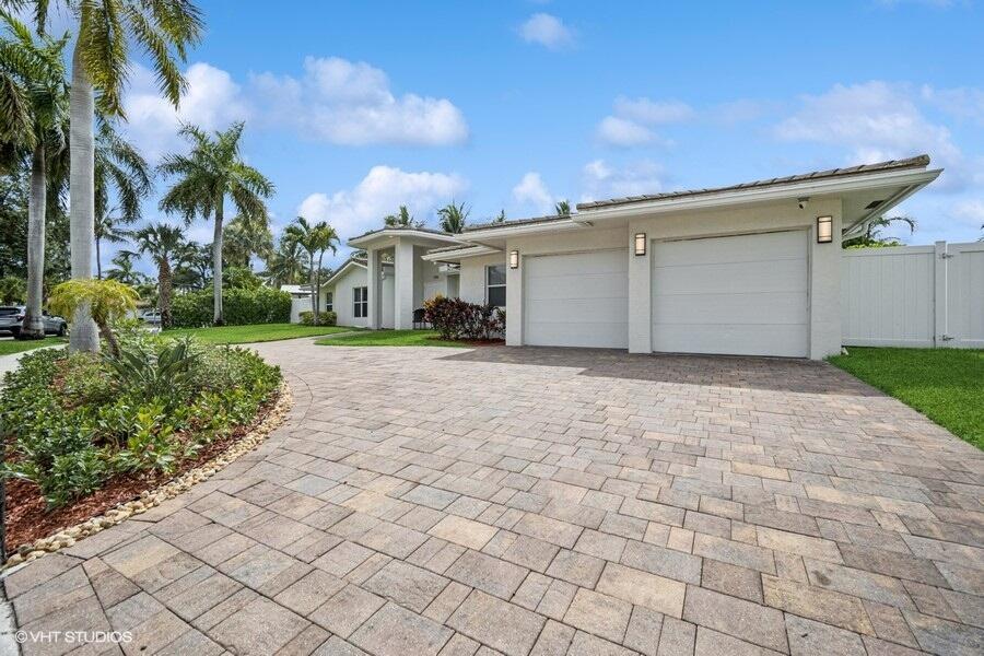 746 Southwest 2nd Street Boca Raton, FL 33486 - Photo 2 of 54 a view of a white house with a yard and plants