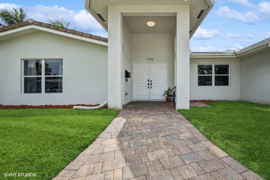746 Southwest 2nd Street Boca Raton, FL 33486 - Photo 3 of 54 a view of an house with backyard space and garden