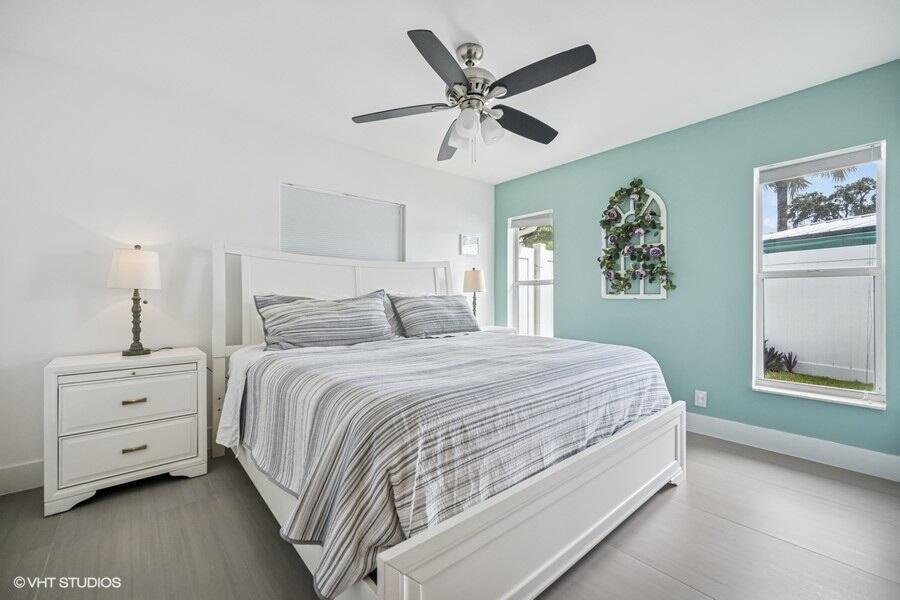 746 Southwest 2nd Street Boca Raton, FL 33486 - Photo 31 of 54 a bedroom with a bed and a chandelier