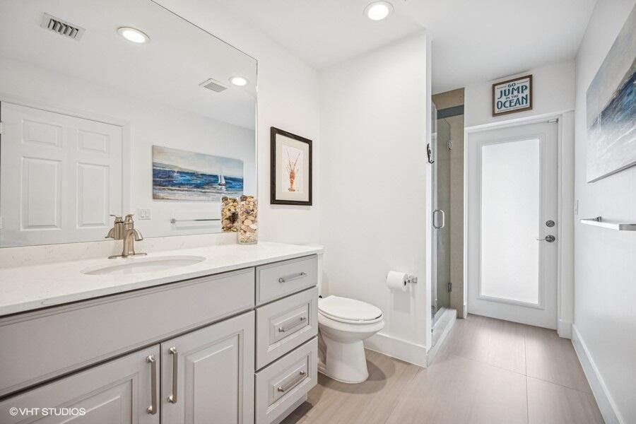746 Southwest 2nd Street Boca Raton, FL 33486 - Photo 39 of 54 a bathroom with a granite countertop sink mirror vanity and toilet