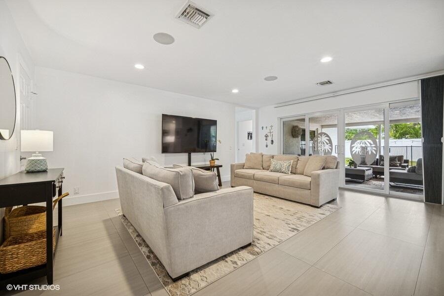 746 Southwest 2nd Street Boca Raton, FL 33486 - Photo 4 of 54 a living room with furniture and a flat screen tv