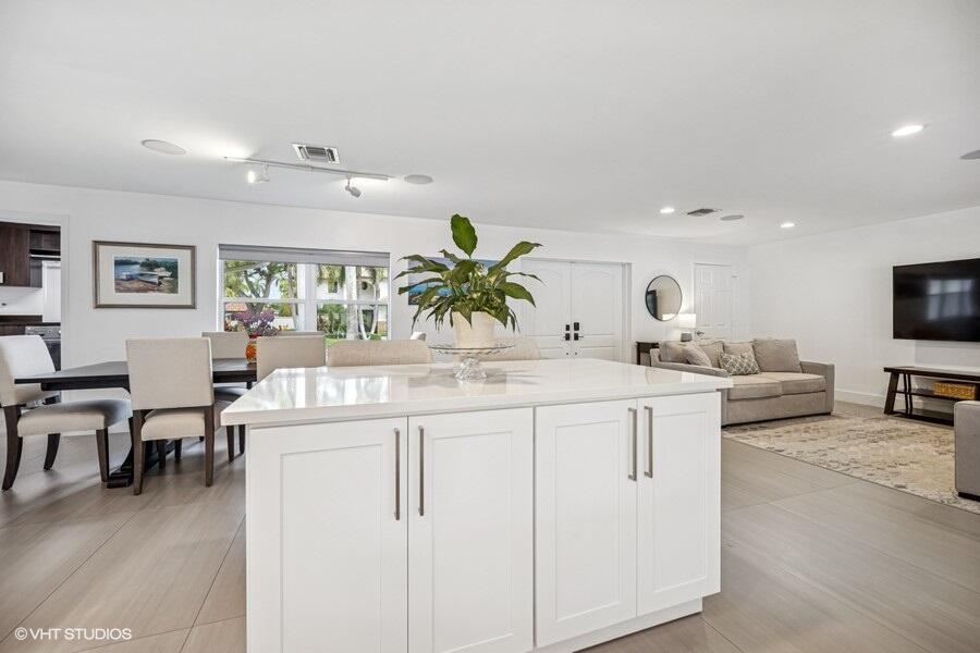 746 Southwest 2nd Street Boca Raton, FL 33486 - Photo 7 of 54 a living room with furniture a dining table and a potted plant
