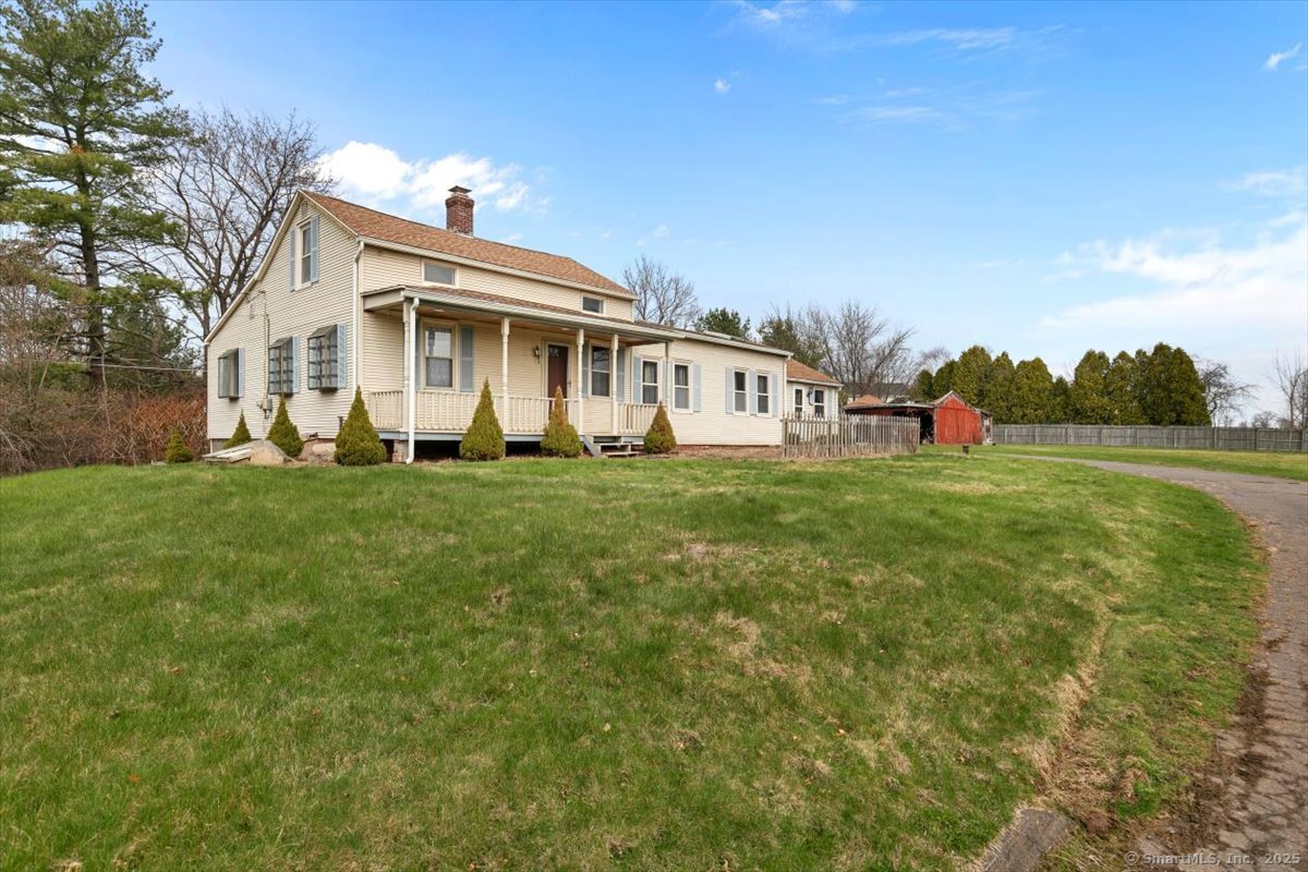 72 Spencer Street Suffield, CT 06078 - Photo 1 of 1 a front view of a house with a yard and trees