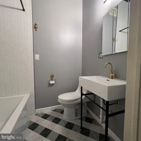 a bathroom with a tub and a shower