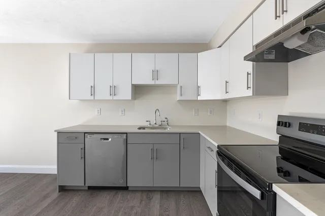 a kitchen with a sink stove and cabinets