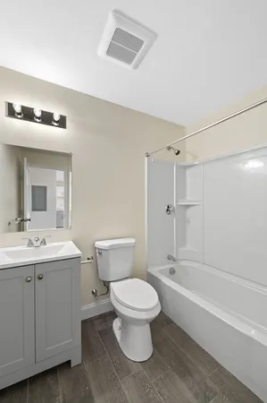 a bathroom with a toilet sink and shower