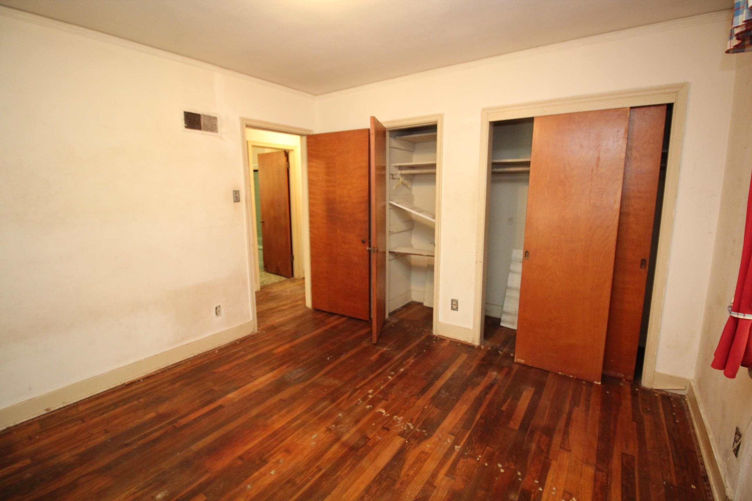 1079 Alden Road Memphis, TN 38116 - Photo 20 of 40 Interior room featuring wood-finish flooring, two wooden doors, and built-in closet shelving