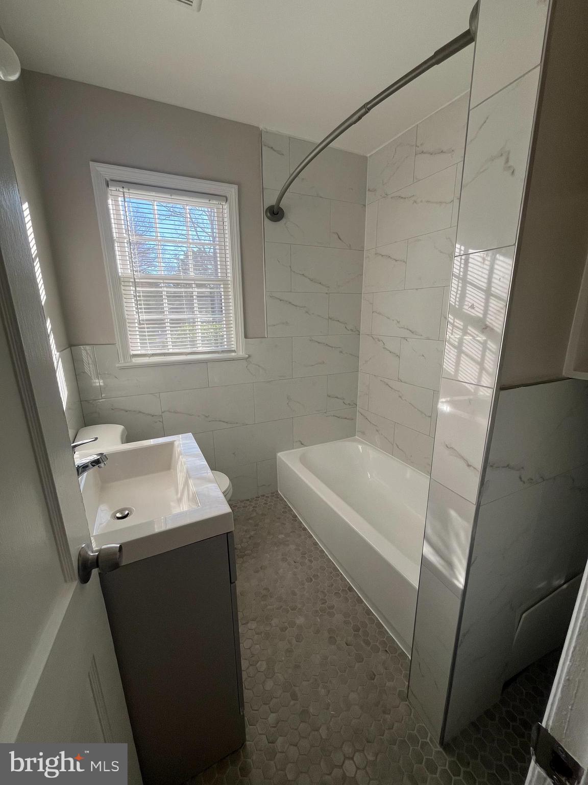 7908 Wellington Road Alexandria, VA 22308 - Photo 12 of 16 a bathroom with a sink a toilet and shower