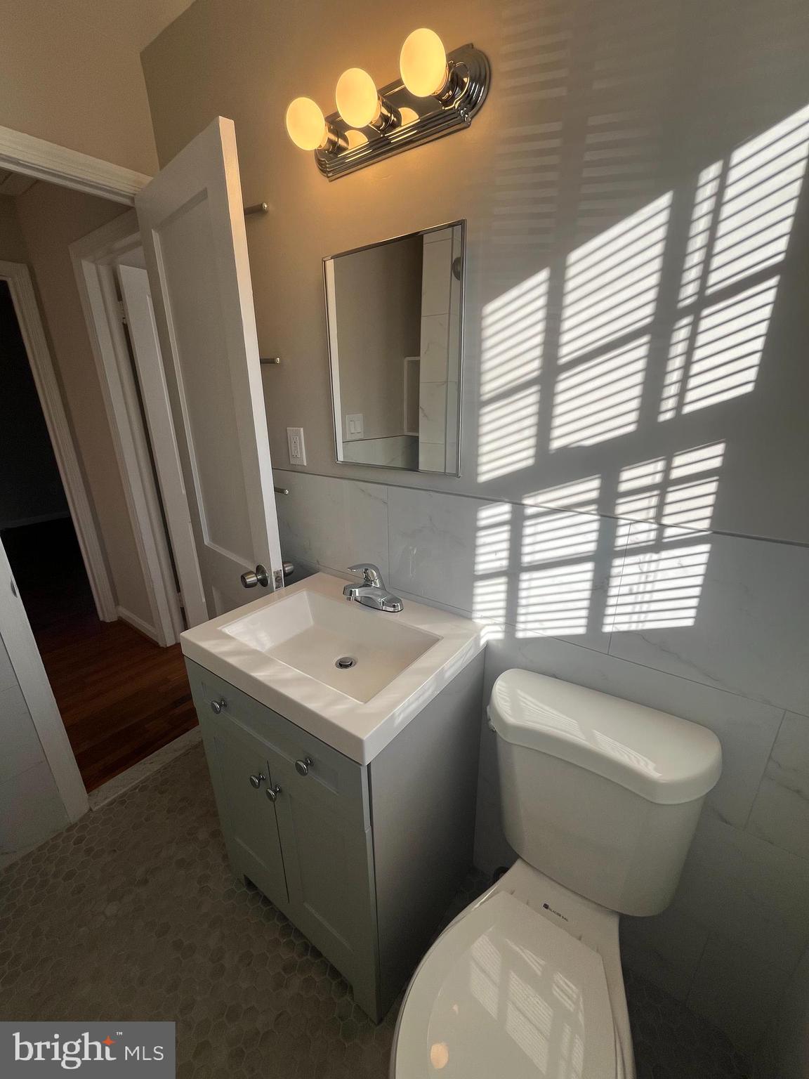 7908 Wellington Road Alexandria, VA 22308 - Photo 13 of 16 a bathroom with a toilet sink and mirror