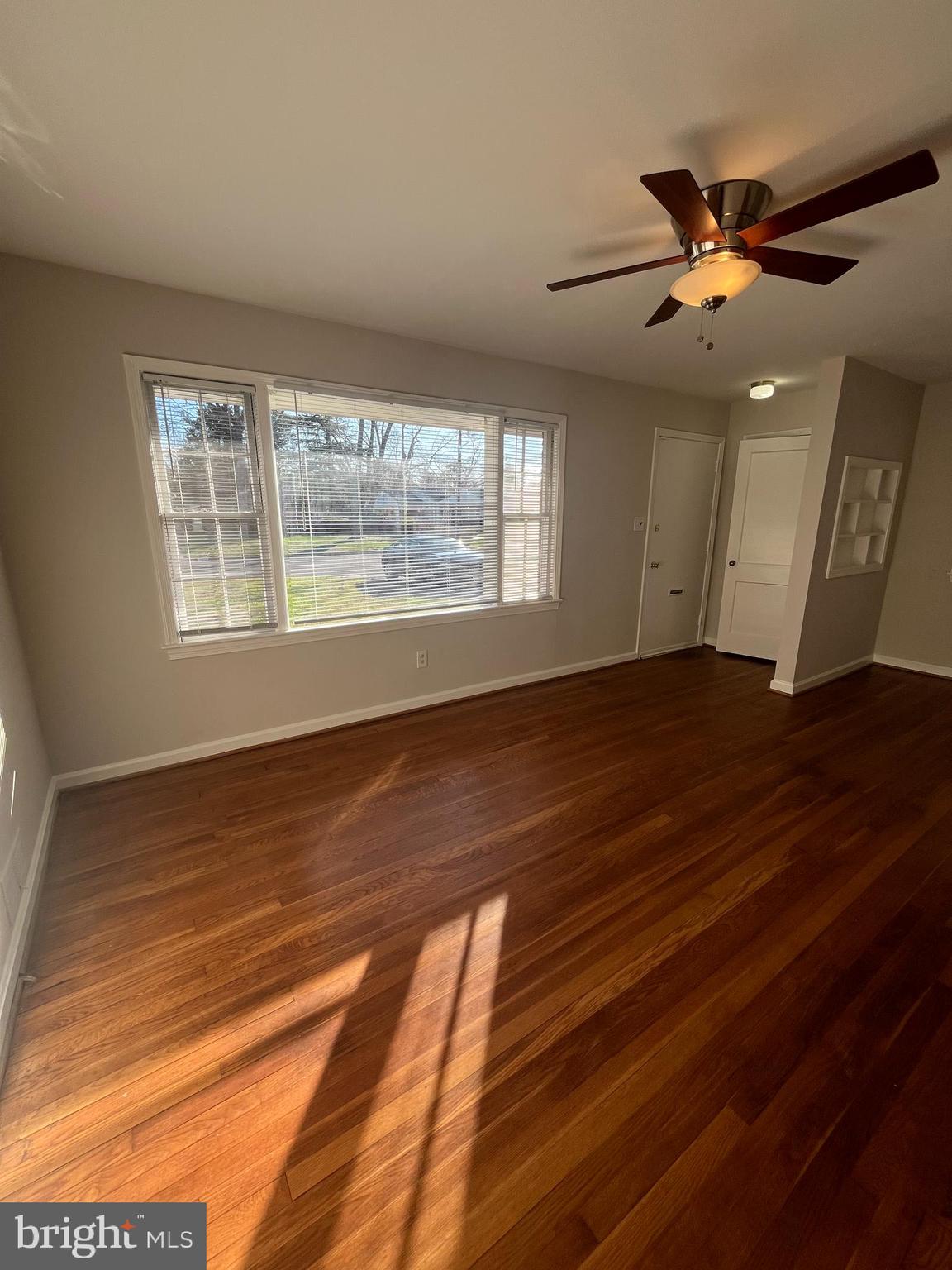 7908 Wellington Road Alexandria, VA 22308 - Photo 5 of 16 a view of an empty room with wooden floor and a window