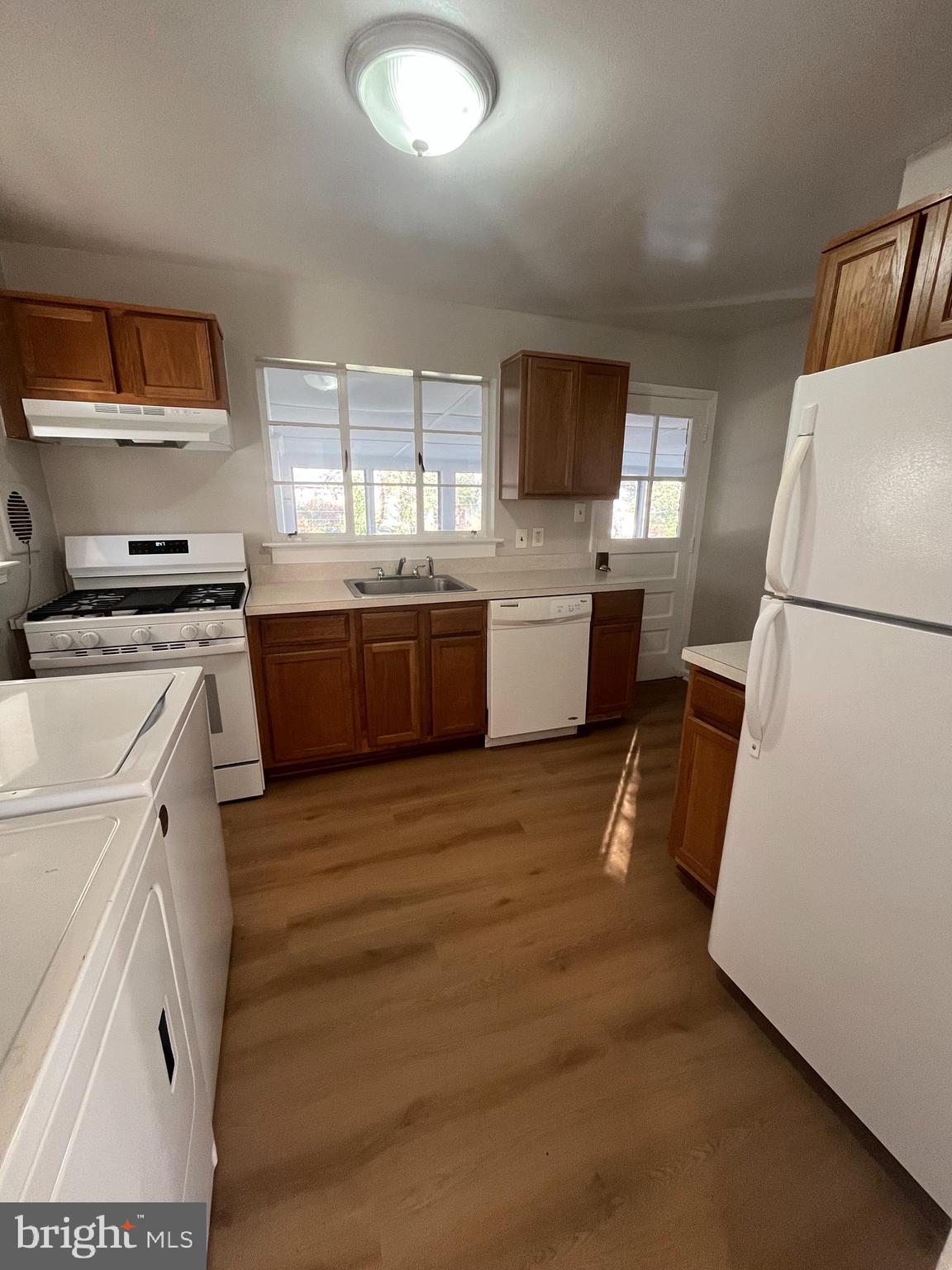 7908 Wellington Road Alexandria, VA 22308 - Photo 7 of 16 a kitchen with a stove a sink and a refrigerator