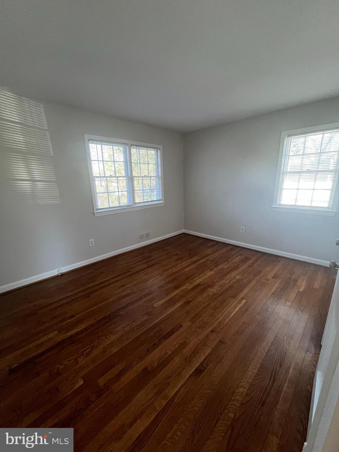 7908 Wellington Road Alexandria, VA 22308 - Photo 10 of 16 wooden floor in an empty room with a window