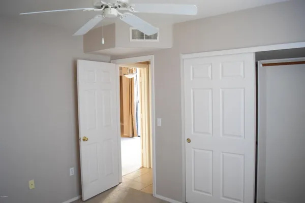 a view of a hallway with a chandelier fan