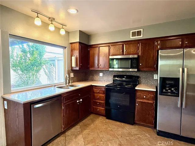 a kitchen with a stove a sink and a microwave