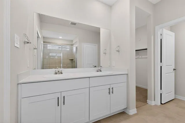 a bathroom with a double vanity sink and mirror