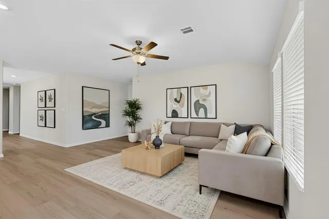 a living room with furniture and a wooden floor
