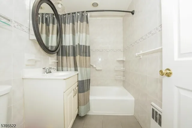 a bathroom with a sink a mirror a bathtub and a shower