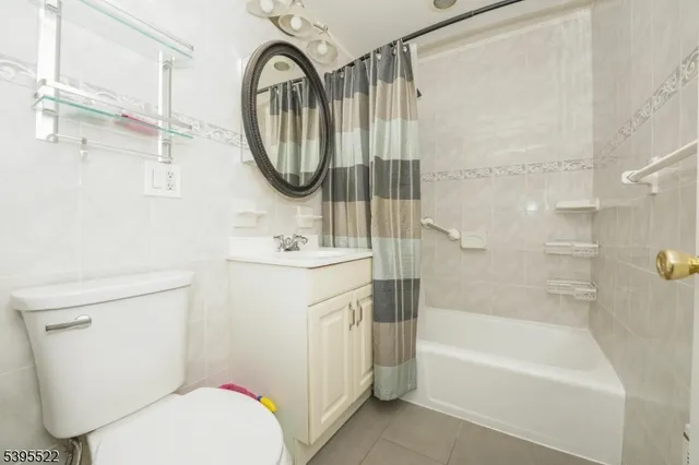 a bathroom with a sink a mirror a toilet and a bathtub