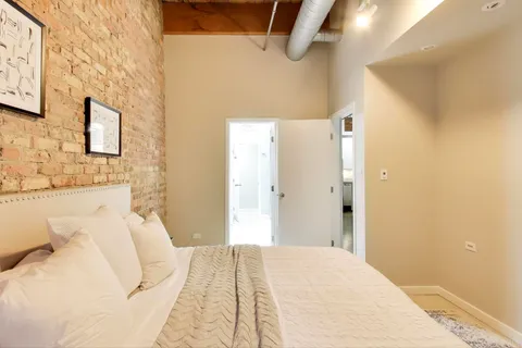 a bedroom with a bed and a mirror