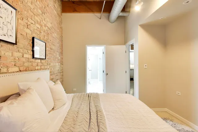 a bedroom with a bed and a mirror