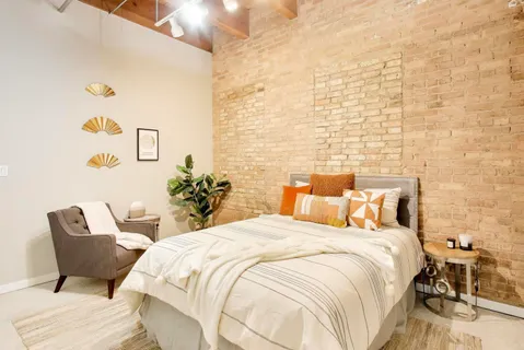 a bedroom with a bed and a chair