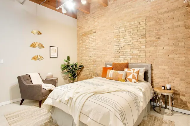 a bedroom with a bed and a chair