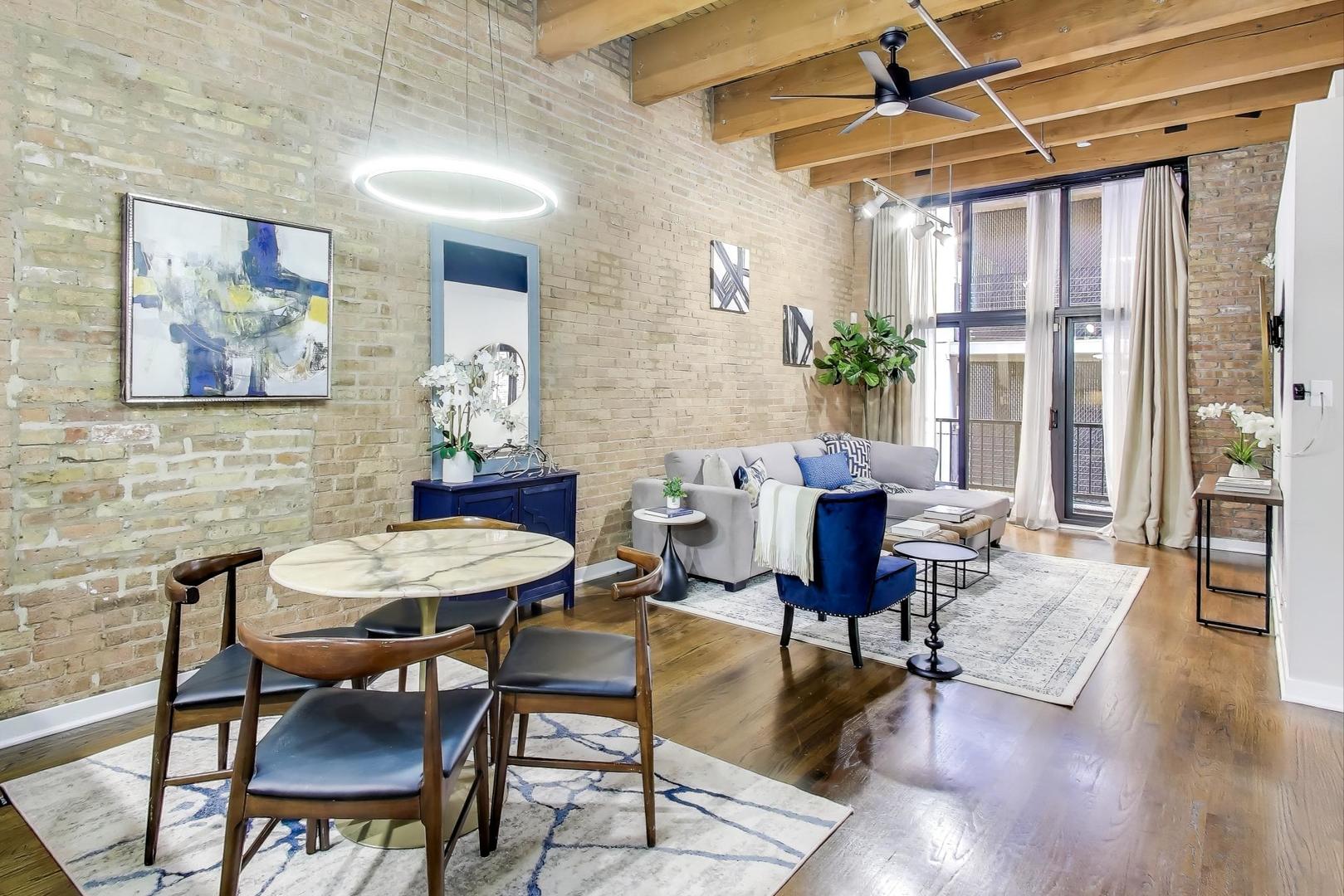 300 West Grand Avenue, Unit 210 Chicago, IL 60654 - Photo 4 of 20 a view of a livingroom with furniture and a table