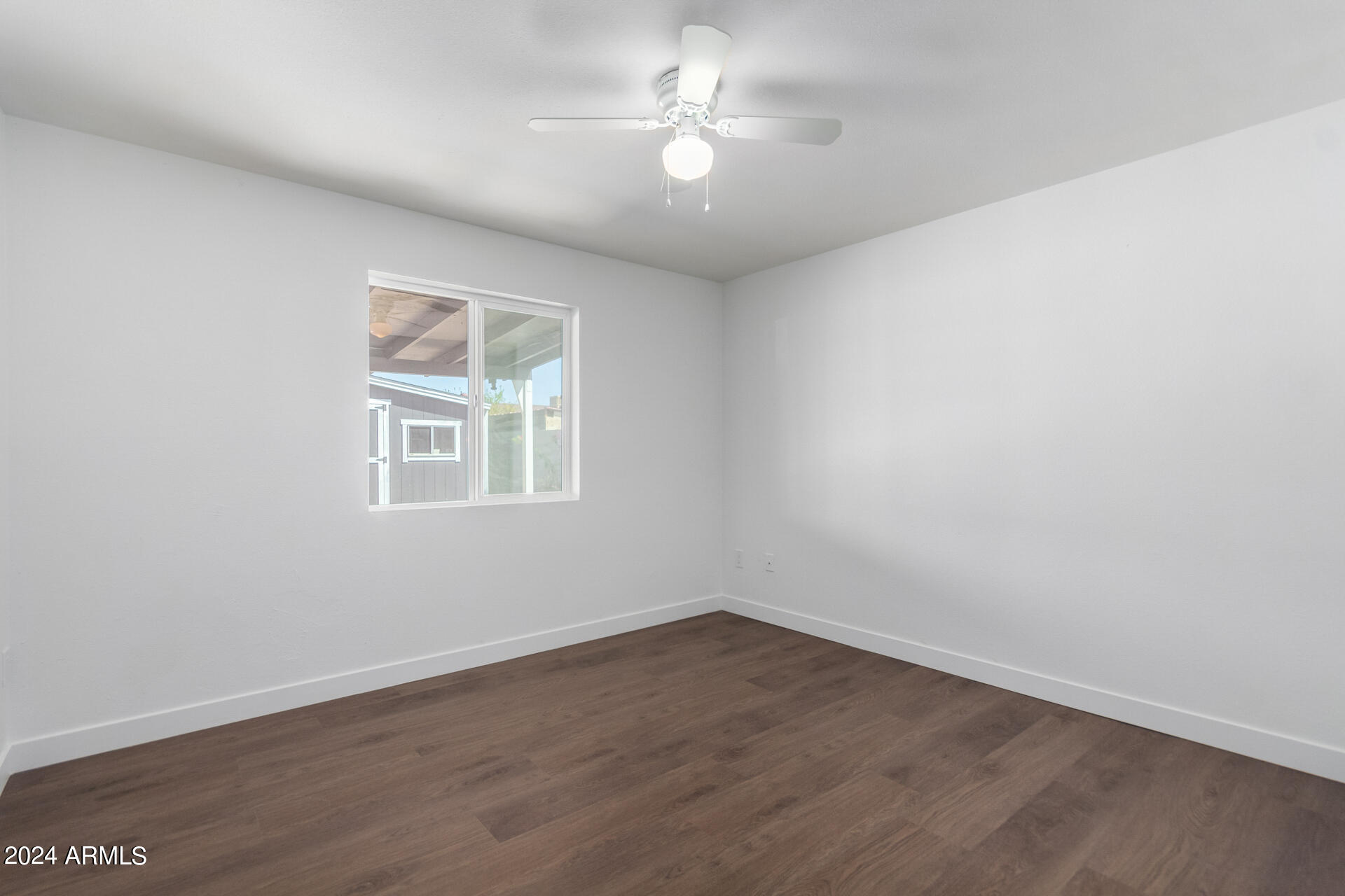 5338 West Coronado Road Phoenix, AZ 85035 - Photo 13 of 29 wooden floor in an empty room with a window